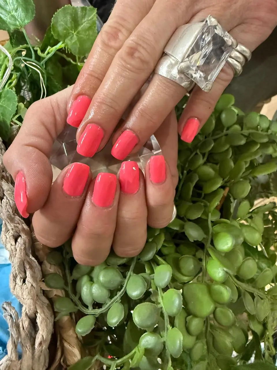 Glossy coral-pink nails