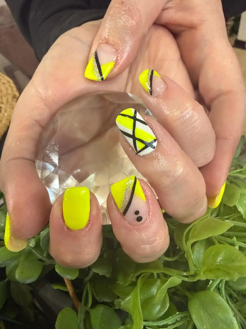 Neon yellow nails with black and white geometric line art