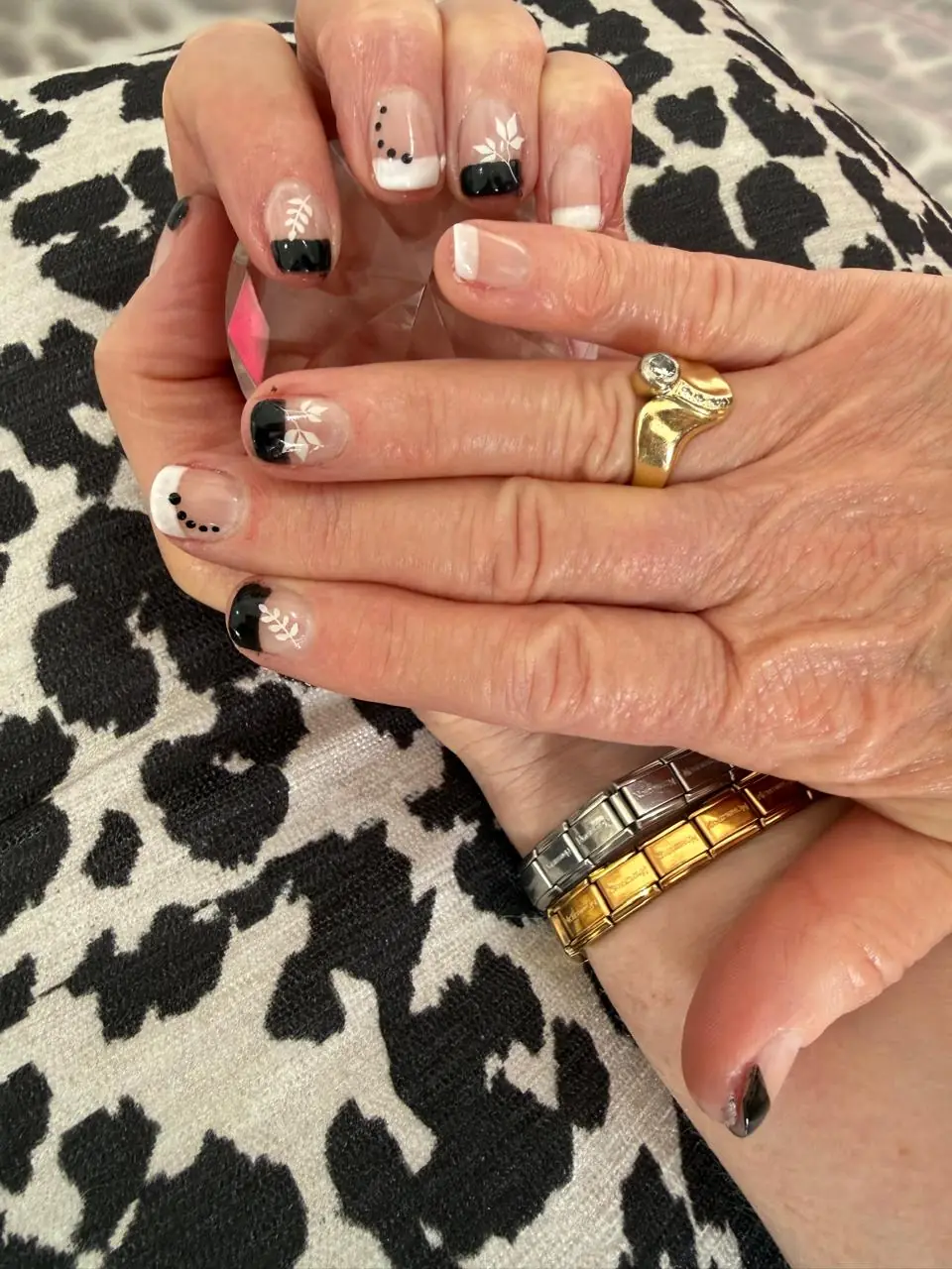Black and nude French nails with fine white botanical details