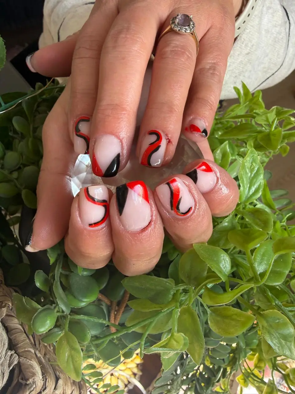 Red, black and nude nails with flowing abstract line art