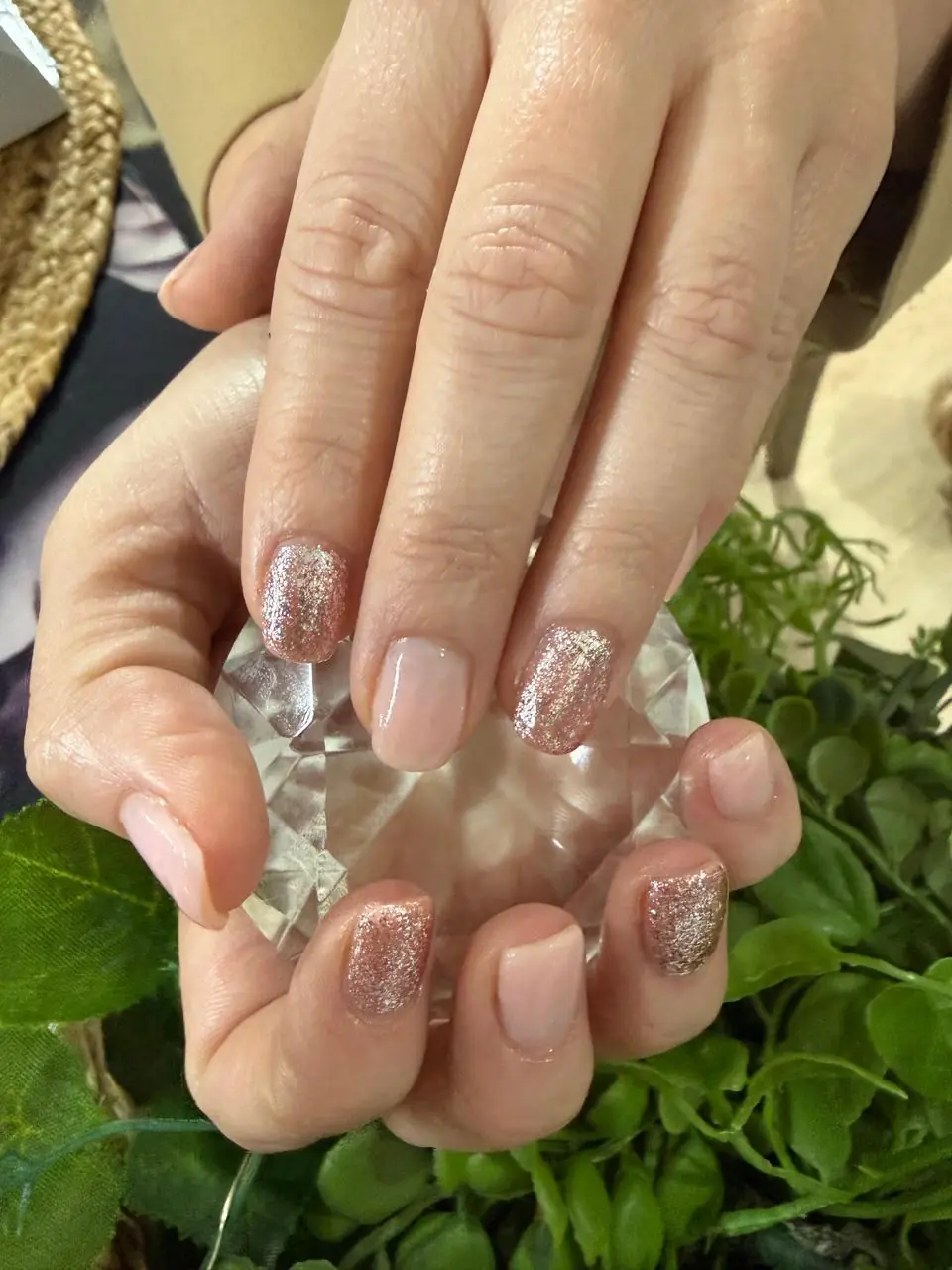 Blush nails with rose-gold glitter accents